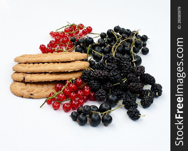 Black and red currants, mulberry and cereal biscuits on a white background