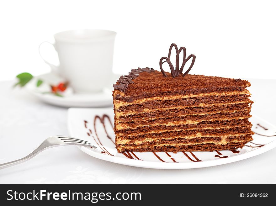 Sweet chocolate cake on table with tea cup