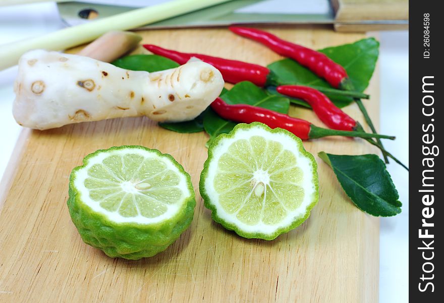 Kaffir lime on chopping block prepare for cooking. Kaffir lime on chopping block prepare for cooking