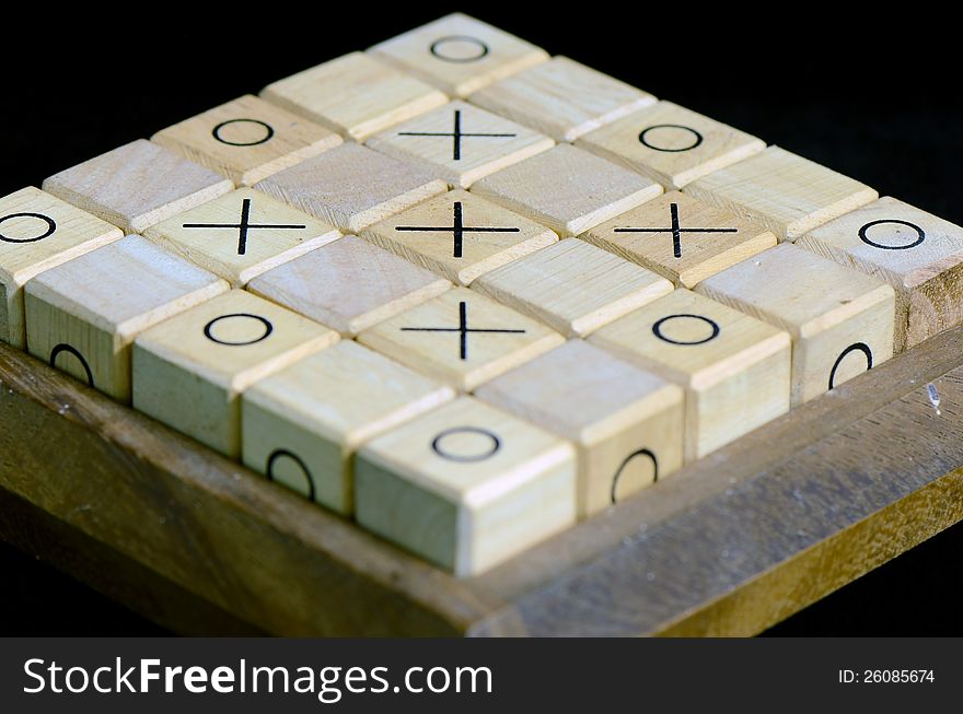 Wooden boxes with sign x and o on black background. Wooden boxes with sign x and o on black background.