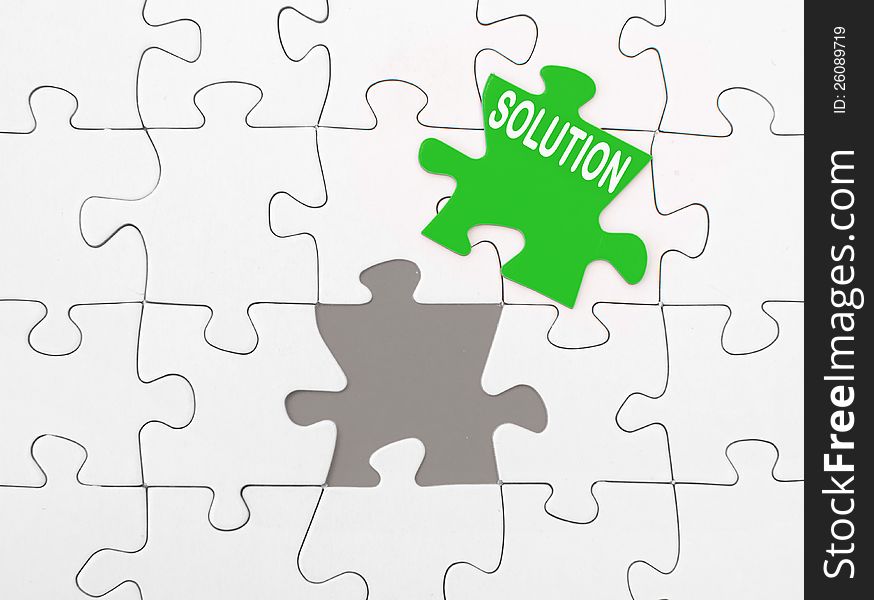 Solution on green missing piece of a jigsaw puzzle
