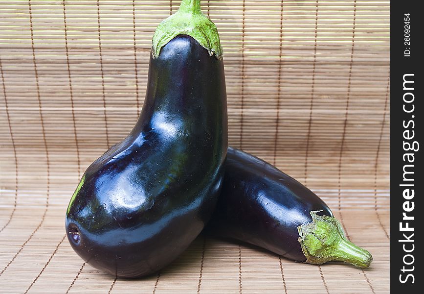 Two eggplants on wood background