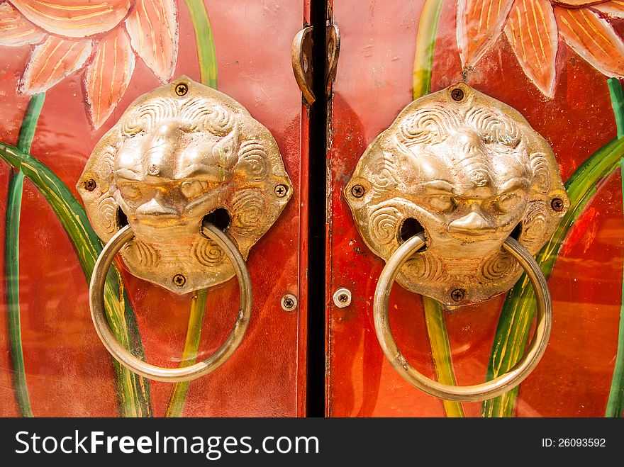 Golden handle on the door of chinese shrine