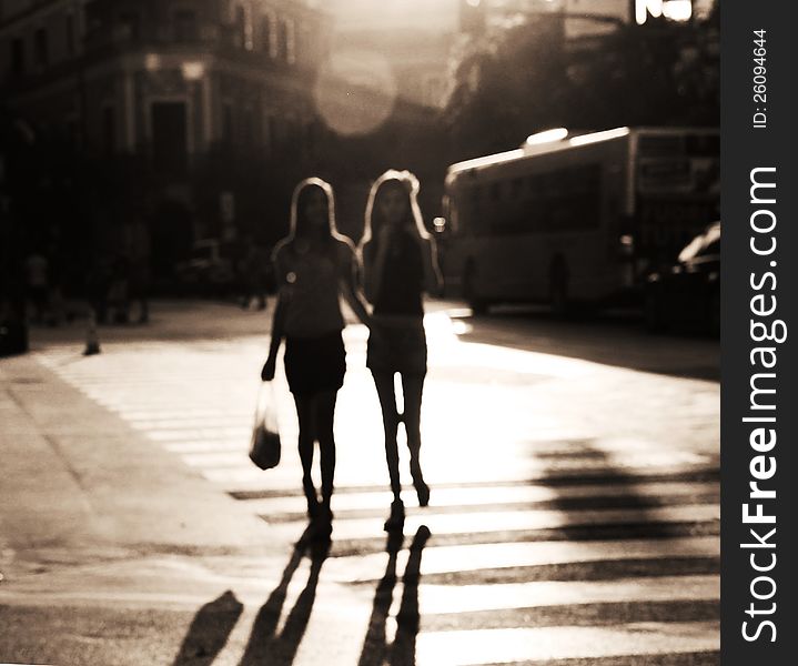 Two girls crossing the street