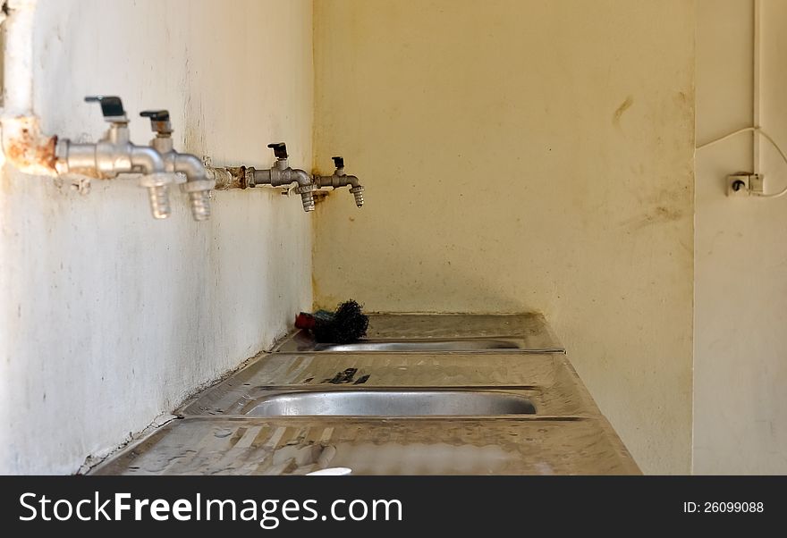 Sinks lined up in a poor residential area. Sinks lined up in a poor residential area