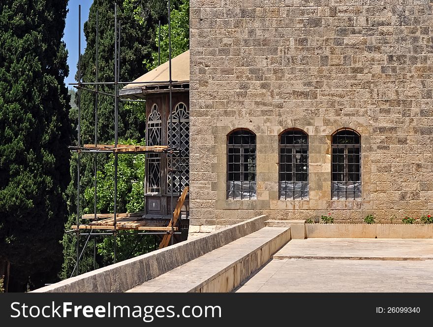 Scaffolding is used to renovate an old palace of stone. Scaffolding is used to renovate an old palace of stone