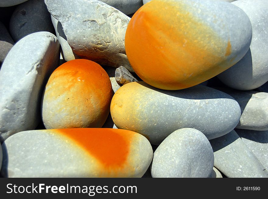 Pebbles with a rusty orange deposit. Pebbles with a rusty orange deposit