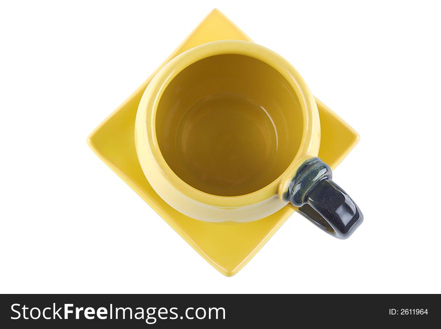 Top view of an empty yellow teacup on square saucer. Top view of an empty yellow teacup on square saucer