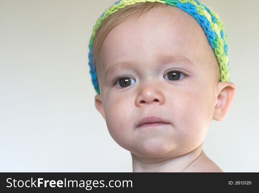 Image of beautiful toddler with a serious look on his face