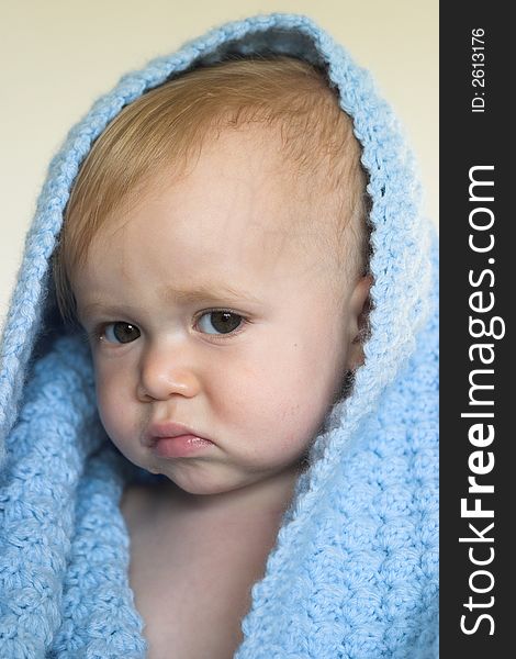 Image of a cute toddler peeking out from under a blanket. Image of a cute toddler peeking out from under a blanket