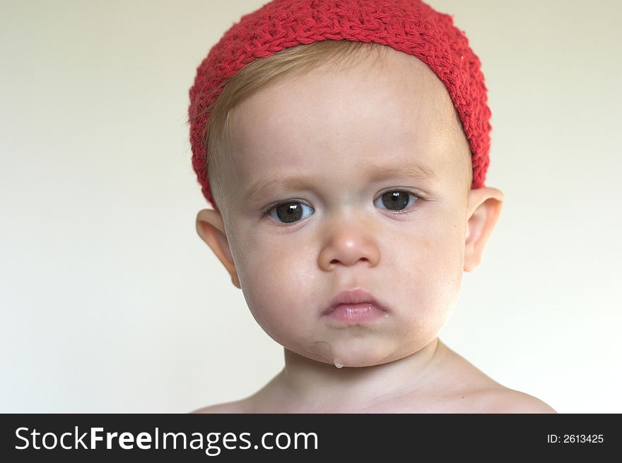 Image of beautiful toddler wearing a crochet cap