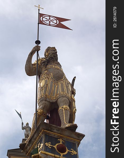 Golden statue on old house