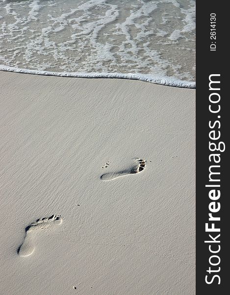 Footprints in the sand on a white maldivian beach