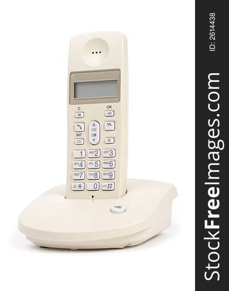 Single cream colored telephone isolated over white background. Single cream colored telephone isolated over white background
