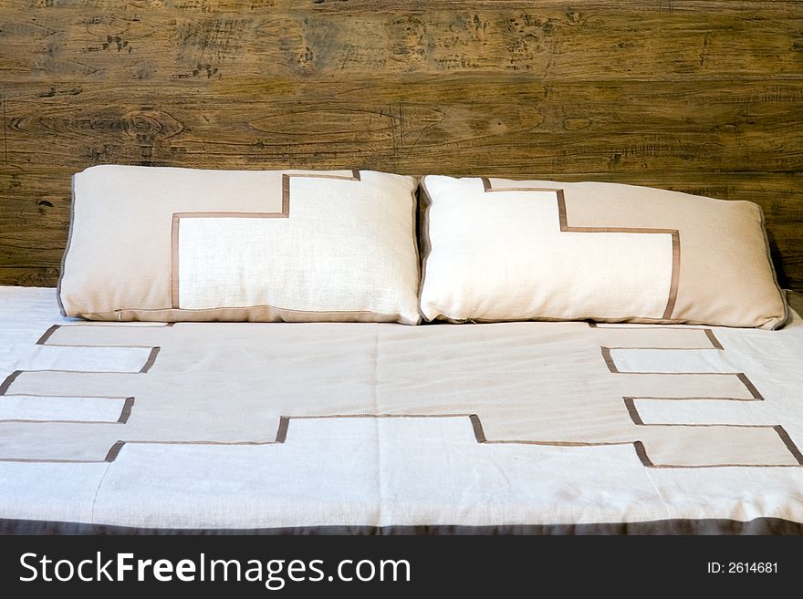 Oold-style wooden bed with pillows