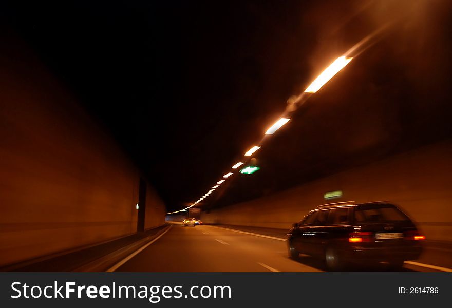 Fast driving throug a tunnel in the night. The picture shows you speed and danger