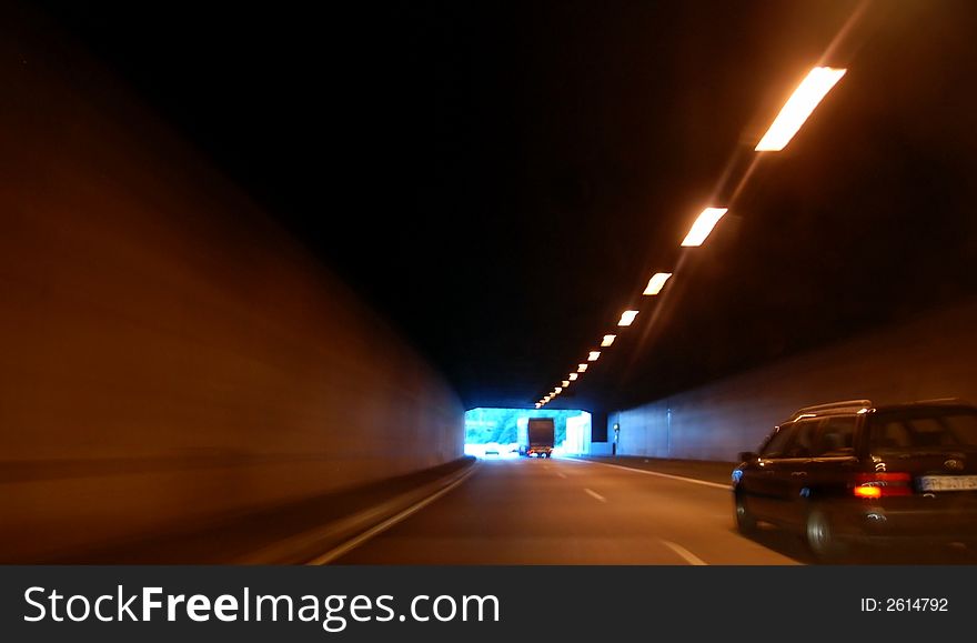 Fast driving throug a tunnel in the night. The picture shows you speed and danger
