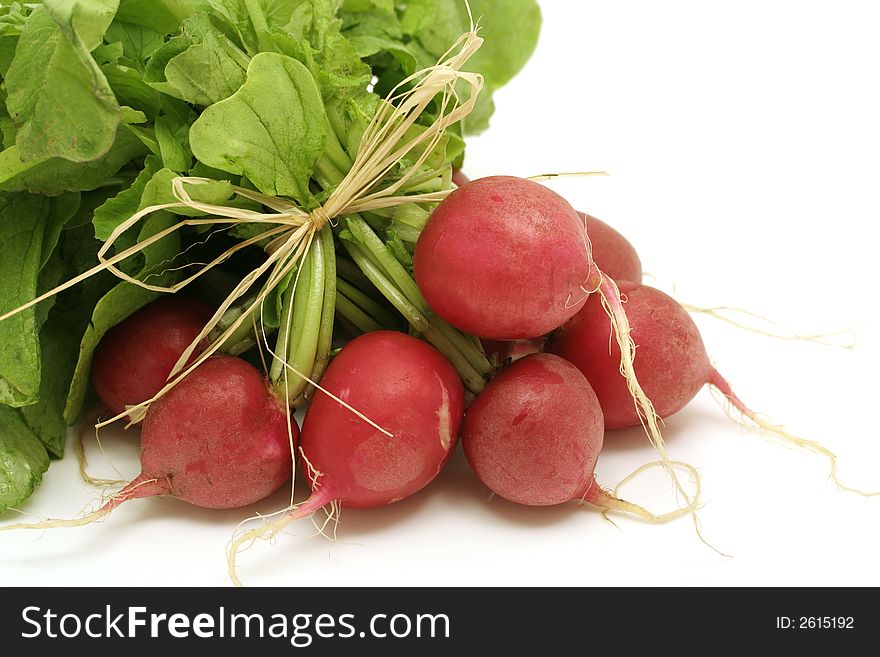 Bundle of fresh radishes on white background