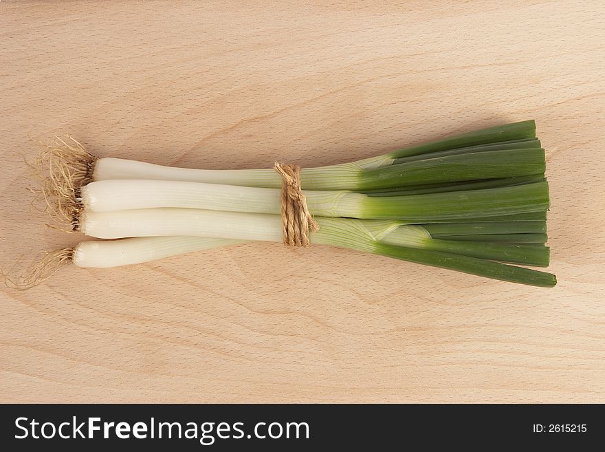 Fresh onion on a wooden bottom