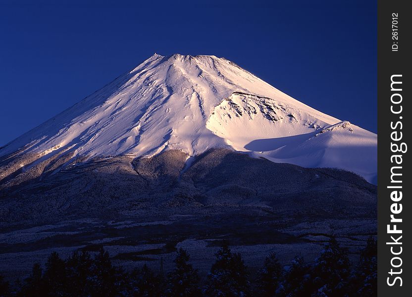 Morning sun illuminating the peak of Mount Fuji on a clear Winter's day. Morning sun illuminating the peak of Mount Fuji on a clear Winter's day