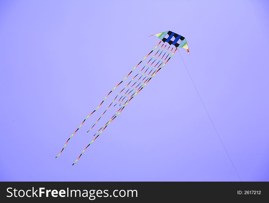 Colorful kite flying in the blue sky. Colorful kite flying in the blue sky