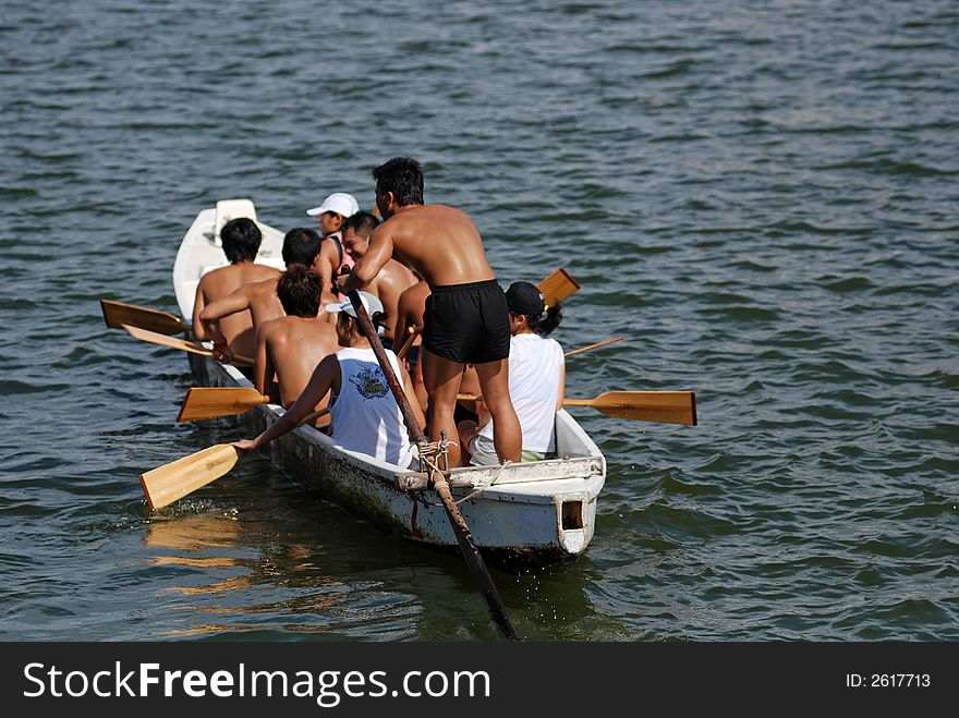 People practicing rowing at the seaside