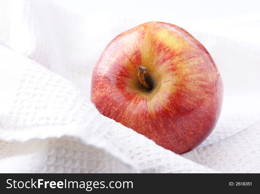 Perfect apple covered by white cloth