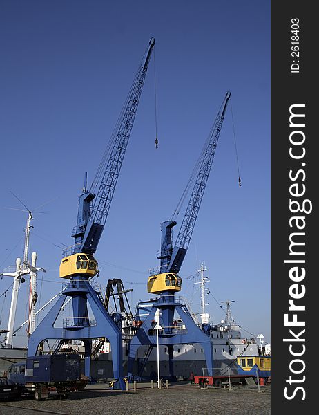 Blue and yelllow crane on dock