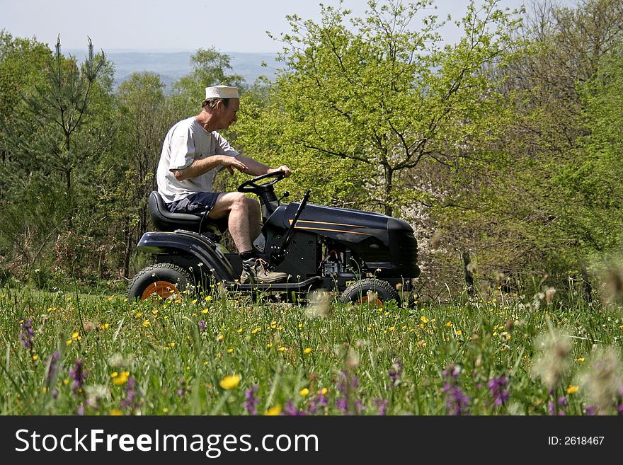 Man Sitting On Lawnmover