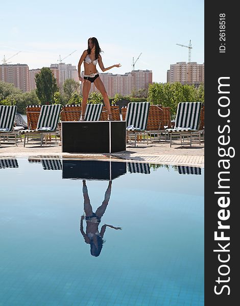 Woman dancer near the pool