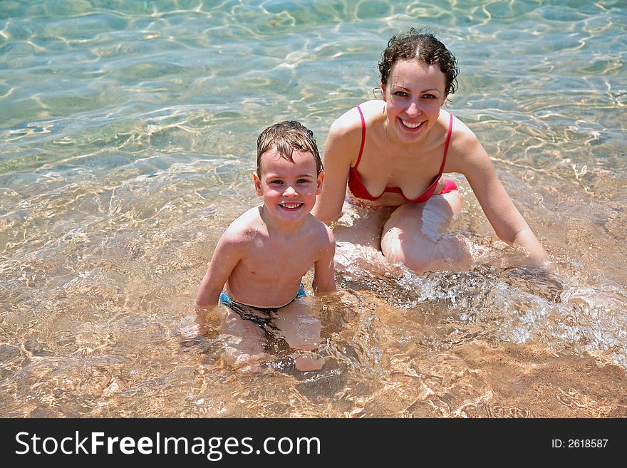 Mother and son in water. Mother and son in water