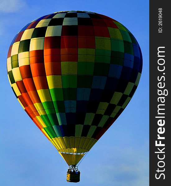 Soaring hot air balloon lifting off the ground. Soaring hot air balloon lifting off the ground