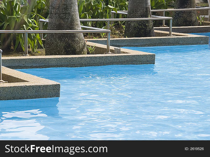 part of free form swimming pool at a resort hotel. part of free form swimming pool at a resort hotel