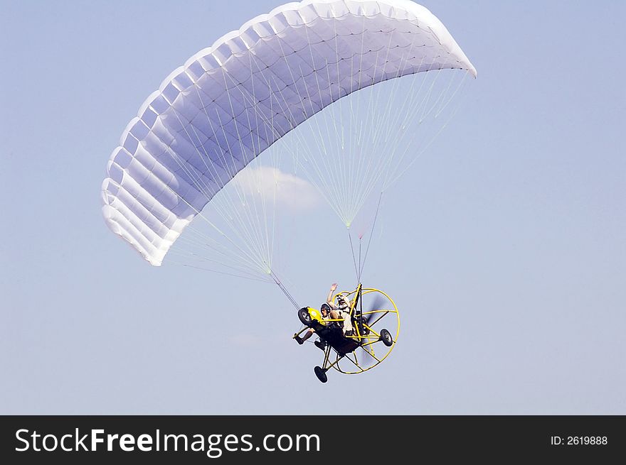 Para-motor - motorized paraglide flying in the sky