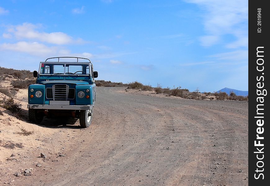 A 4WD picup truck parked at a desert country road. A 4WD picup truck parked at a desert country road