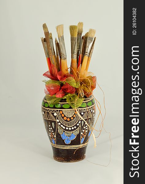Paint brushes in decorated vase. Paint brushes in decorated vase.