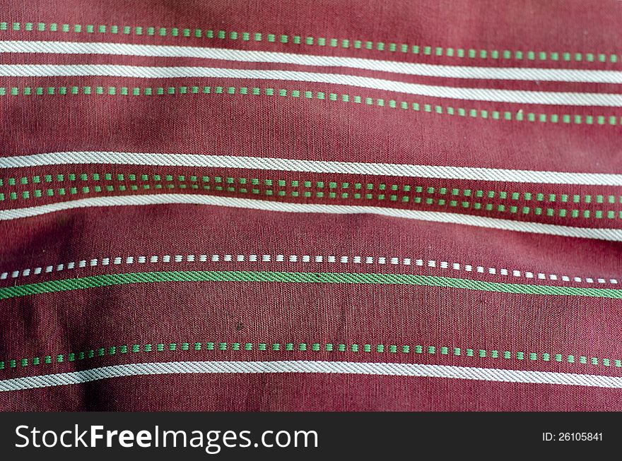 Fabric with pink and white pattern, with green dots. Fabric with pink and white pattern, with green dots