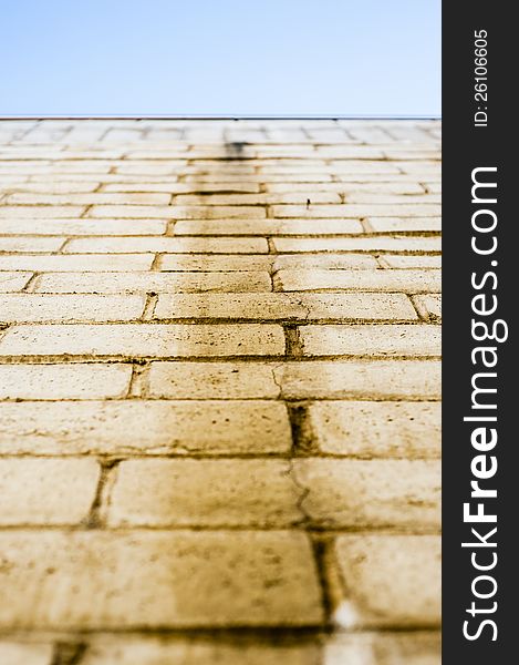 Yellow brick wall/floor/path leading to blue sky. Yellow brick wall/floor/path leading to blue sky.