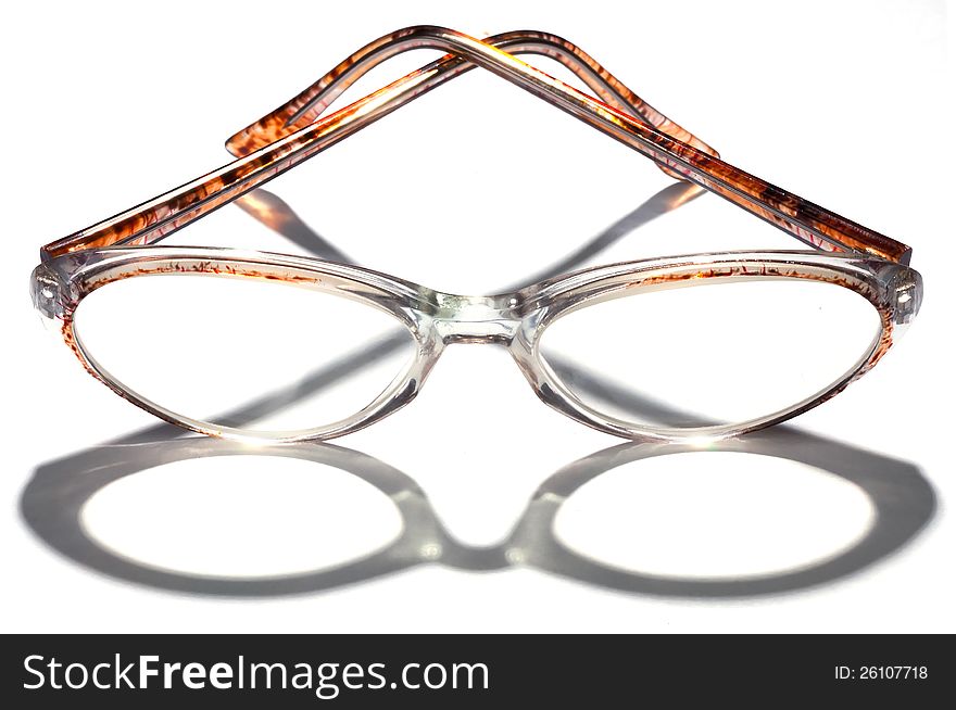 Glasses in a transparent plastic frame with a shadow