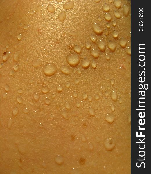 The surface of a human skin with droplets of water. The surface of a human skin with droplets of water