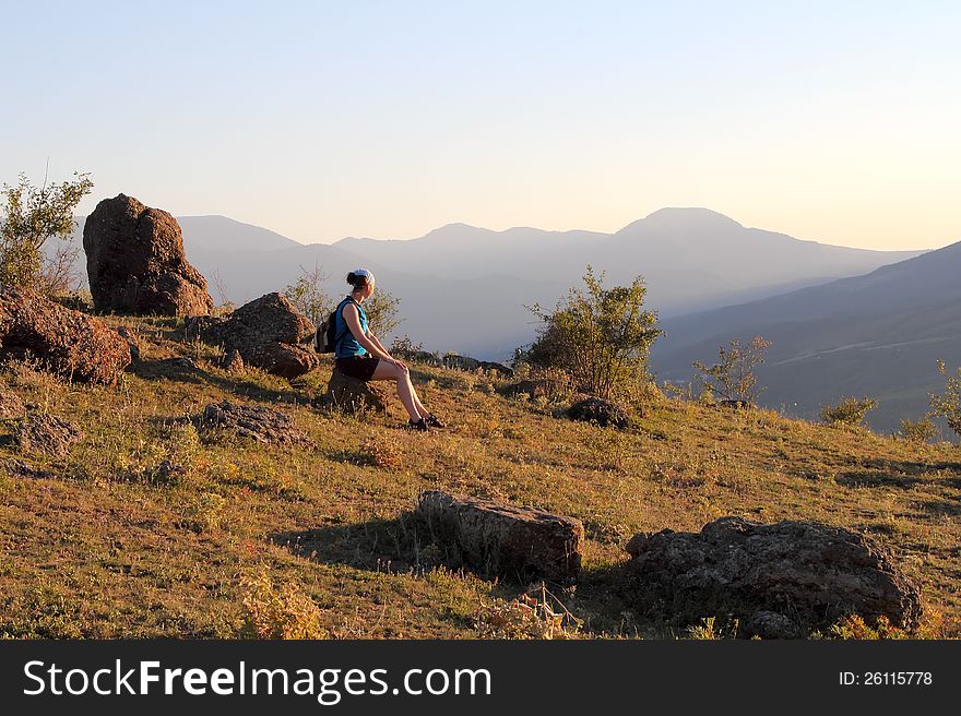 Girl seats on a rock in the valley of gosts. Girl seats on a rock in the valley of gosts