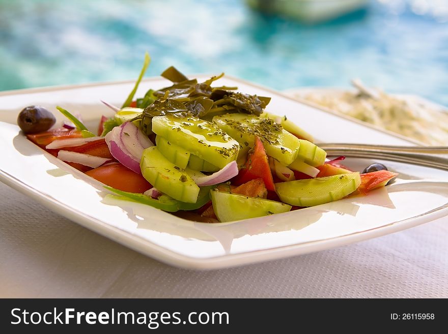 Traditional Greek Salad on Sea Background. Traditional Greek Salad on Sea Background