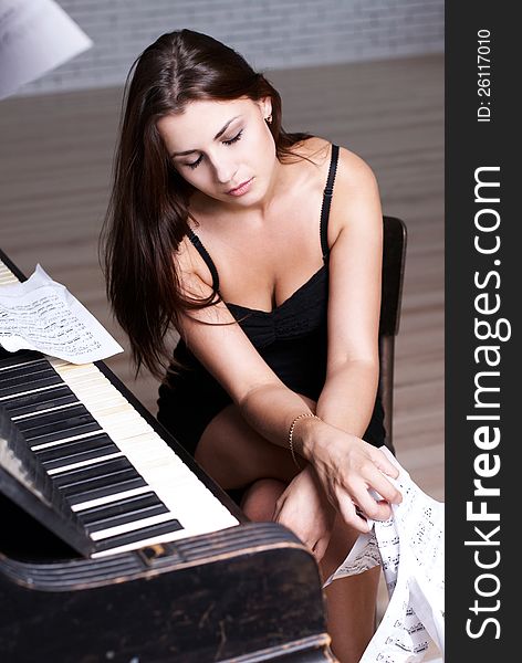Sad girl near piano