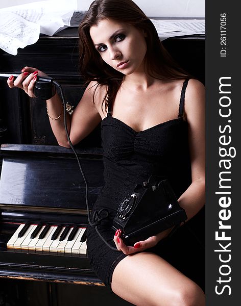 Sad Girl Near Piano With Retro Phone