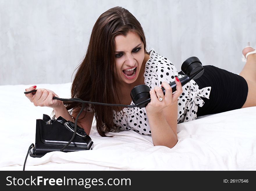 Brunette talking on the retro phone