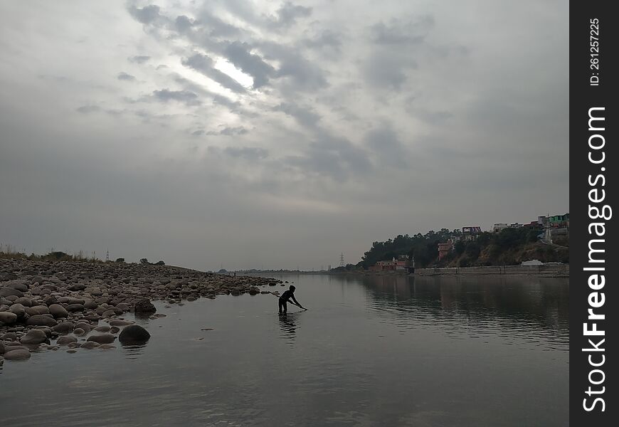 fishing in shallow water in Akhnoor, Jammu