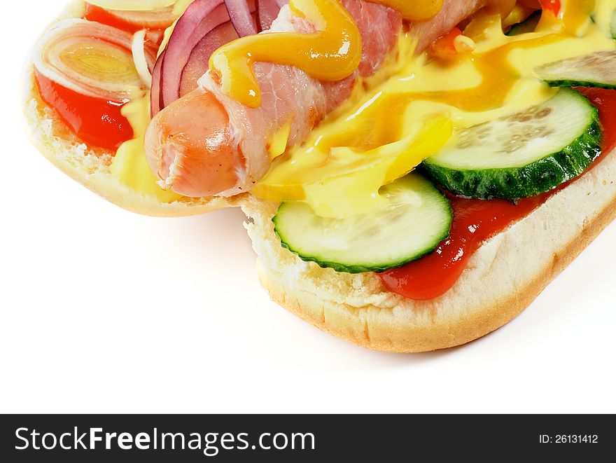 Inside View of Hot Dog with Sausage, Bacon, Cucumber, Onion, Ketchup and Mustard close up  on white background