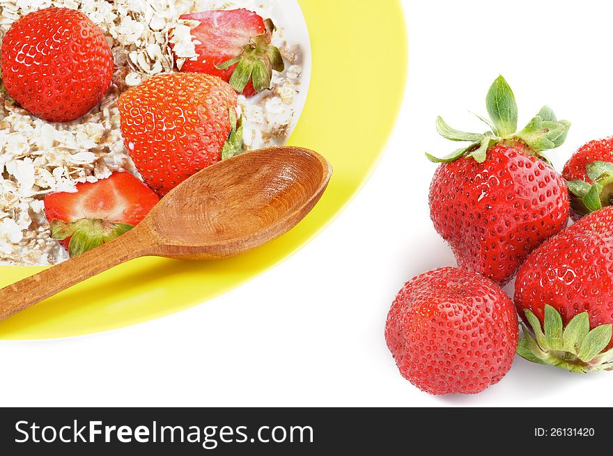 Healthy Muesli, Milk and Fresh Strawberry on Yellow plate with Wooden Spoon  on white background. Healthy Muesli, Milk and Fresh Strawberry on Yellow plate with Wooden Spoon  on white background