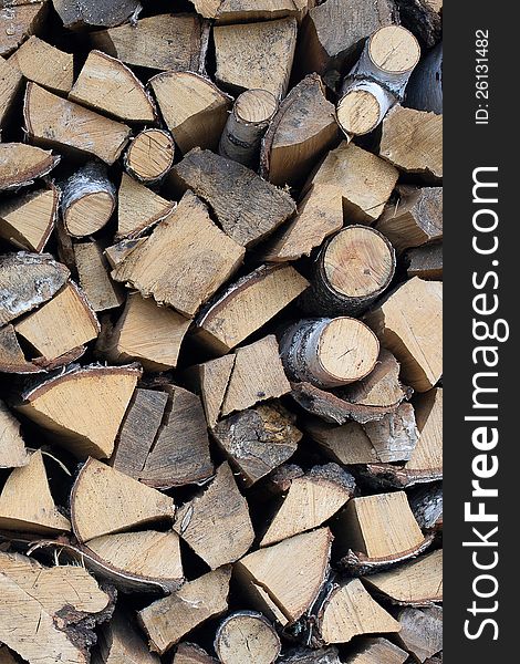Background of dry chopped firewood logs stacked up on top of each other in a pile. Background of dry chopped firewood logs stacked up on top of each other in a pile