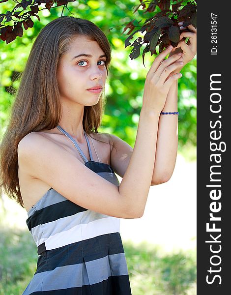 Portrait of beautiful blue eyed girl with long hair in a garden. Portrait of beautiful blue eyed girl with long hair in a garden